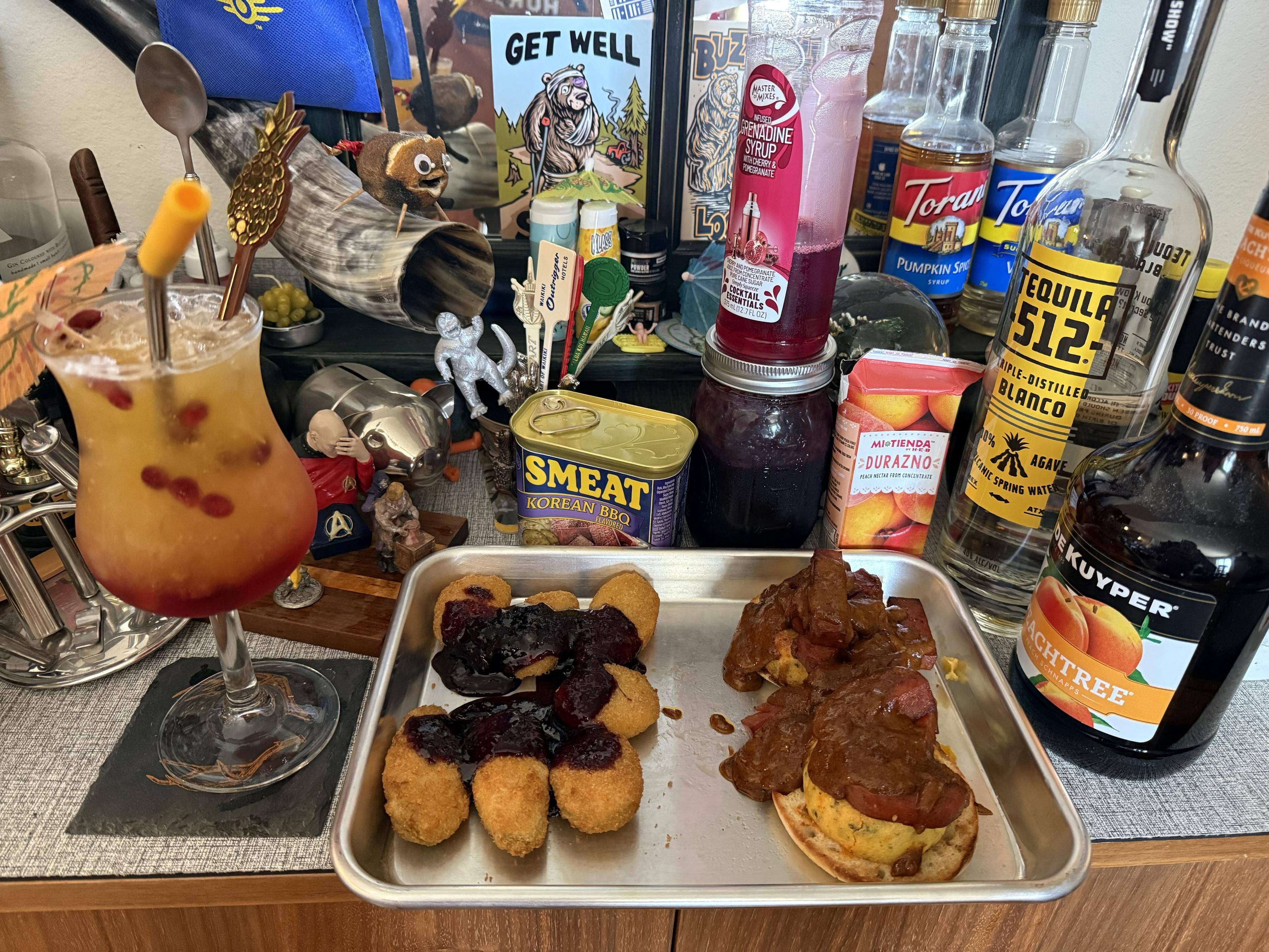 Same cocktail as previous photo but now pictured with a rustic brunch platter. Description of food and drink in both previous picture’s alt text and the toot itself. It’s SPAM, but with a homemade SMEAT logo on it. It really is Korean BBQ flavored, and not bad at all, if you tolerate potted meats…
